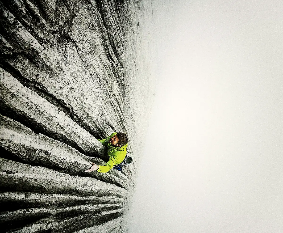 Tommy Caldwell, a small figure in yellow, high on the pale granite of the Dawn Wall, El Capitan